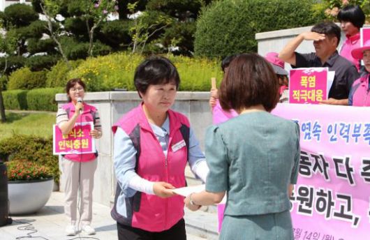 박쌍순 전국학교비정규직노조 경남지부장이 경남교육청 관계자에게 학교 급식소 폭염 대책 요구안을 전달하고 있다. 이세령 기자