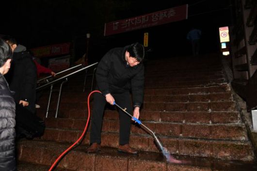 화천산천어축제 관계자들이 10일 새벽 토치로 계단 얼음을 녹이고 있다. 화천군 제공