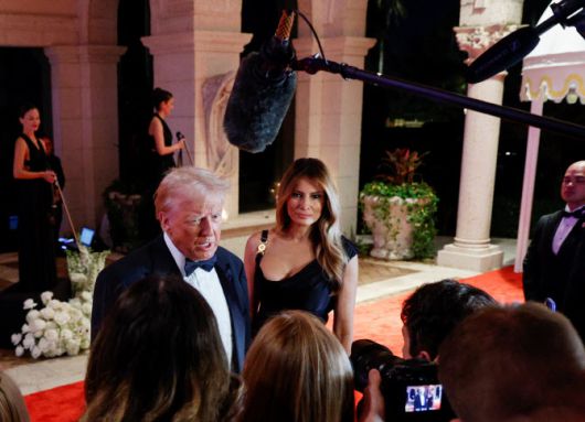 U.S. President-elect Donald Trump, accompanied by his wife Melania, attends a New Year‘s Eve event at Mar-a-Lago in Palm Beach, Florida, U.S., December 31, 2024. REUTERS/Marco Bello