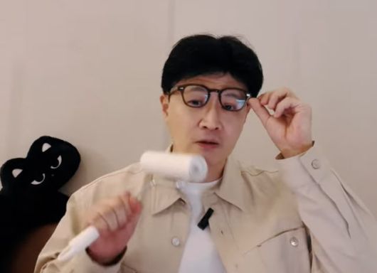 한동훈 전 국민의힘 대표가 라이브 방송에서 돌돌이 얼굴에 묻은 고양이 털을 떼고 있는 모습.  (사진=유튜브 캡처)