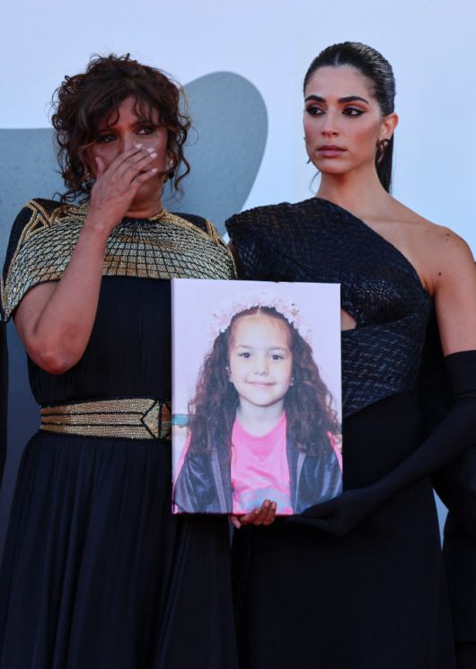 이스라엘군의 공격으로 숨진 6세 소녀 힌드 라잡의 사진을 든 채 베니스국제영화제 포토월 앞에 선 영화 ‘힌드 라잡의 목소리’ 출연진들. (사진=로이터)