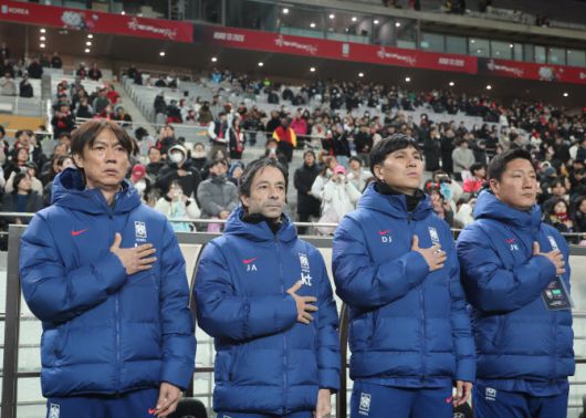 지난달 18일 서울 마포구 서울월드컵경기장에서 열린 남자축구 국가대표 A매치 평가전 대한민국과 가나의 경기에서 홍명보 감독 등 코치진이 국기에 경례하고 있다.  사진=연합뉴스