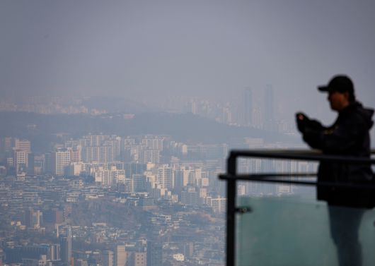 서울의 대기가 초미세·미세먼지 나쁨을 기록하고 있는 10일 서울 남산을 찾은 관광객들이 뿌연 대기에 잠긴 서울 시내를 바라보고 있다. /연합뉴스