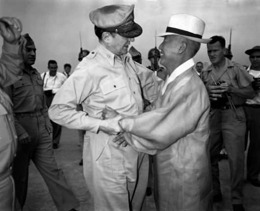 KOREA BECOMES INDEPENDENT NATIONGeneral of the Army Douglas MacArthur, Supreme Commander for Allied Powers, (Left) and Dr. Syngman Rhee, Korea's first President, warmly greet one another upon the General's arrival at Kimpo Air Force Base, at the invitation of President Rhee.  The General and Mrs. MacArthur made the initial trip to Korea, to view an auspicious occasion which spelled freedom and independence for the first time in over forty years. /NARA