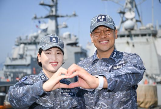 부부 '이지스구축함' 근무자인 율곡이이함 기관장 임재우(오른쪽) 중령진급예정자와 정조대왕함 주기실장 김보아 소령이 율곡이이함 함수갑판에서 '손하트'를 만들고 있다. /해군
