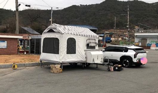 전선이 인근에 세워진 캠핑 트레일러와 차량까지 이어진 모습./보배드림