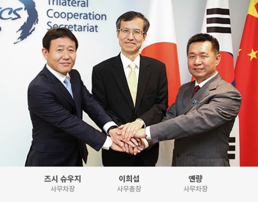 2024년 현 한중일 3국 협력 사무국(TCS)의 이희섭 사무총장(가운데)과 즈시 슈우지 일본측 사무차장(왼쪽), 옌량 중국측 사무차장과 함께 손을 포개며 화합을 다짐하고 있다./TCS 홈페이지