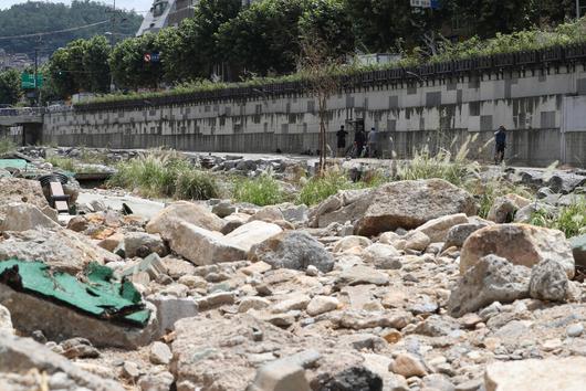 16일 낮 서울 관악구 도림천에서 공사 관계자들이 파손된 산책로 너머로 복구 작업을 하고 있다. 신소영 기자