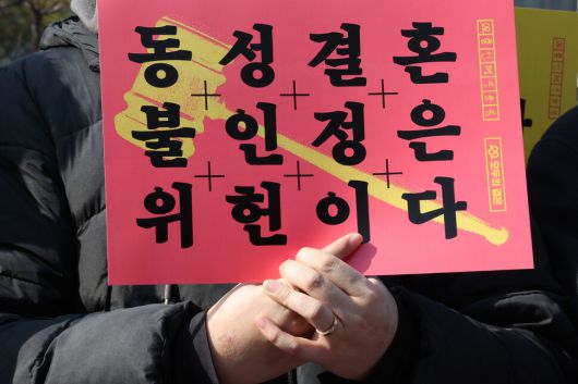 혼인평등 헌법소원 기자회견이 14일 오전 서울 종로구 헌법재판소 앞에서 열려 참석자가 손팻말을 들고 있다. 김태형 기자