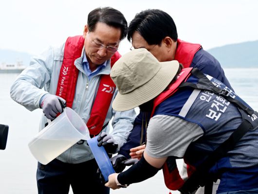 유정복 인천광역시장이 30일 강화군 외포항에서 해수를 채취하고 있다.