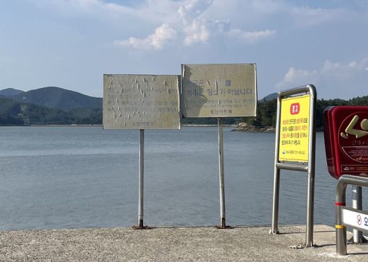 여수시 화양면 오천리 갯벌 일대. 어촌계 경고판(가운데 2개)은 불법 어업과 쓰레기 투기 금지를 설명하고 있으며, 여수시 경고판(오른쪽 1개)은 해상데크 진입이 불가한 교통수단을 안내하고 있다. 녹색연합 해양환경기록단
