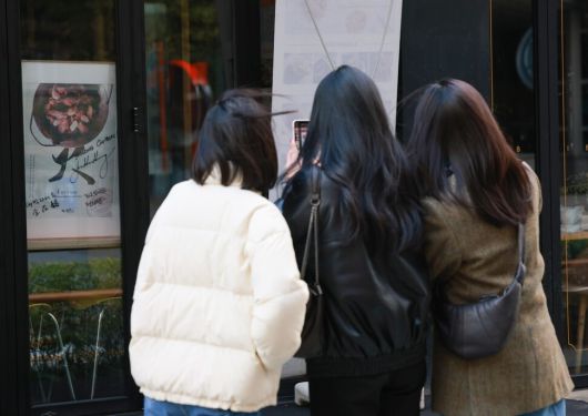 ‘깐부치킨’을 운영하는 주식회사 깐부는 치킨프랜차이즈 17위 기업임에도 젠슨 황 엔비디아 최고경영자, 이재용 삼성전자 회장, 정의선 현대차그룹 회장의 ‘치맥 회동’으로 브랜드 가치가 급상승하는 ‘기적’을 맛봤다. 2025년 11월2일 서울 강남구 깐부치킨 삼성점에 세 사람이 서명한 포스터가 붙어 있다. 연합뉴스