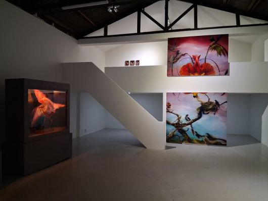 임희재전이 열리고 있는 양평동 홀원 전시장 안쪽 모습. 왼쪽에 투명창 달린 캐비넷 얼개의 그림 진열장이 있고 정면 1, 2층 난간 위아래로 ‘새 천국의 디오라마’ 연작 2점이 내걸려있다. 노형석 기자