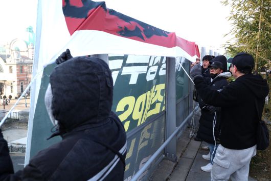 태안화력 고 김충현 비정규직 노동자 사망사고 대책위원회 관계자들이 7일 오전 서울 중구 서울로7017에서 이재명 정부에 한전케이피에스(KPS) 직접고용을 촉구하며 펼침막을 내거는 기습시위를 벌이며 구호를 외치고 있다. 최현수 기자 emd@hani.co.kr