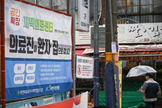 재택 의료에 대한 당국과 각 지자체의 대책은 아직 걸음마 단계다. 사진은 지난해 7월 경기 부천시 부천시민의원 앞에 재택의료 서비스에 관한 현수막이 걸려 있는 모습. 한국일보 자료사진