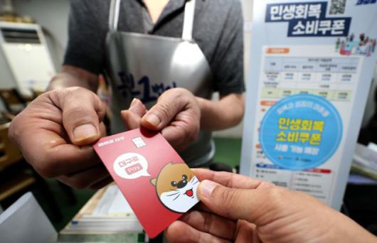 민생회복 소비쿠폰 신청 이틀 째인 22일 대구 중구 한 음식점에서 식사를 마친 시민이 소비쿠폰이 입금된 선불카드로 결제하고 있다. 대구=뉴시스