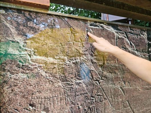 지난 12일 기준 하류에 있는 사연댐의 수위는 56.7m로 반구대 암각화 중 문화관광해설사가 사진 위에서 손가락으로 가리키는 부분을 빼고 모두 물에 잠겼다. 울산=박은경 기자