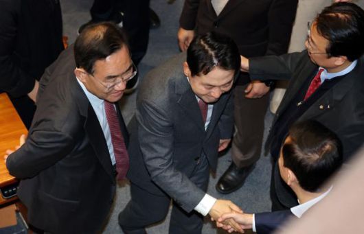 장동혁(가운데) 국민의힘 대표가 23일 국회에서 열린 12월 임시국회 본회의에서 12·3 윤석열 비상계엄 등에 대한 전담재판부 설치 및 제보자 보호 등에 관한 특별법에 대한 반대토론으로 역대 최장 필리버스터(무제한 토론을 위한 합법적인 의사진행 방해) 기록을 세운 뒤 주호영(왼쪽) 국회부의장 등 동료 의원들과 인사를 나누고 있다. 연합뉴스