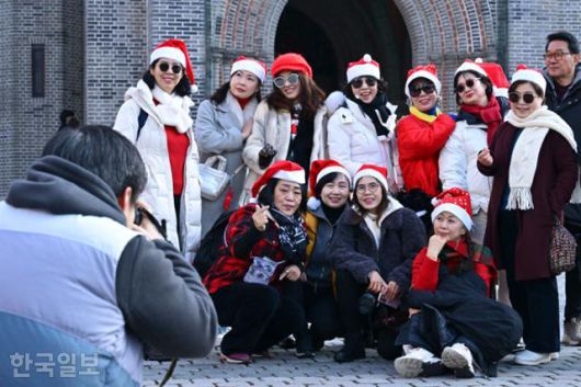 성타절을 하루 앞둔 24일 서울 중구 명동성당에서 산타 복장을 한 방문객들이 기념사진을 촬영하고 있다. 강예진 기자