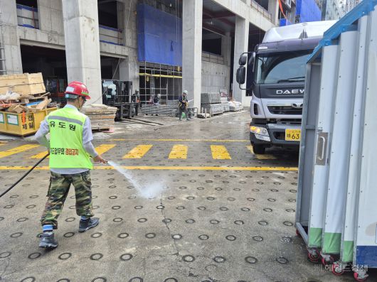 지난 8일 오후 서울에서 기록적인 폭염이 관측된 가운데 종로구의 한 건설 현장에서 근로자가 바닥에 물을 뿌리고 있다. 김도윤 기자.