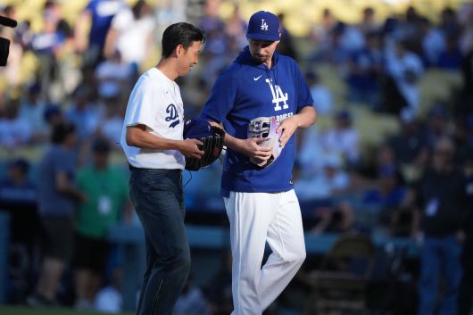Aug 27, 2025; Los Angeles, California, USA;  Los Angeles Dodgers pitcher Blake Snell (7) walks with LAFC soccer forward Son Heung-min (7) at Dodger Stadium. Mandatory Credit: Kirby Lee-Imagn Images