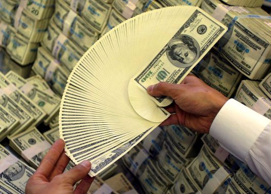 한 외환 딜러가 달러를 세고 있다.[게티이미지]