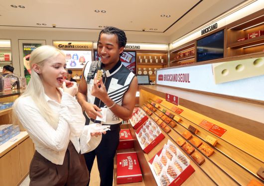 신세계면세점 명동점 ‘테이스트 오브 신세계’ 브릭샌드 매장에서 시식을 즐기는 외국인 관광객들 [신세계면세점 제공]