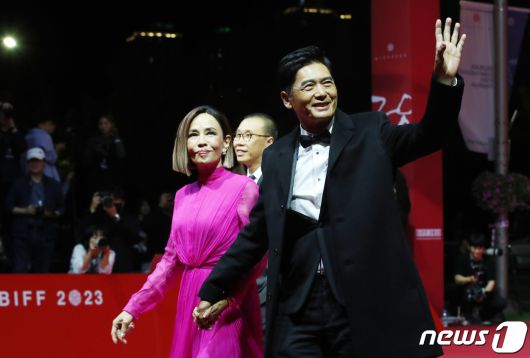 배우 주윤발(저우룬파)이 4일 오후 부산 해운대구 영화의전당에서 열린 ‘제28회 부산국제영화제’(BIFF) 개막식에 아내 진화련과 함께 참석해 인사를 하고 있다. ⓒ News1 권현진 기자