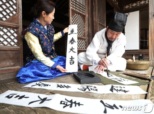 절기상 입춘(立春)을 사흘 앞둔 1일 경기 용인시 기흥구 한국민속촌에서 직원들이 새해의 복을 기원하는 마음을 담아 입춘첩을 쓰고 있다 입춘첩에는 보통 ‘입춘대길(立春大吉) 건양다경(建陽多慶)’(봄이 시작되니 크게 길하고, 경사스러운 일이 많이 생긴다.), ‘소지황금출(掃地黃金出) 개문만복래(開門萬福來)’(땅을 쓸면 황금이 생기고 문을 열면 만복이 온다) 등의 글씨를 써 붙였다. 봄을 기다리는 마음과 한 해 동안의 길한 운과 경사스러움이 가득하기를 기원하는 의미가 담겨있다. 2024.2.1/뉴스1 ⓒ News1 김영운 기자