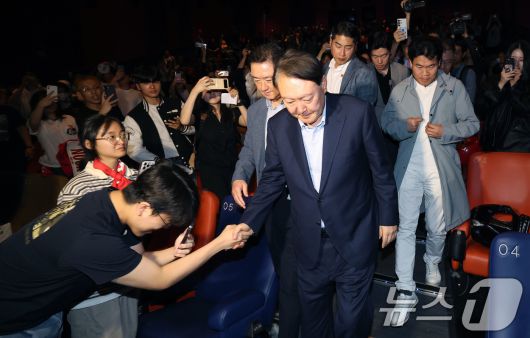 윤석열 전 대통령이 21일 오전 서울 메가박스 동대문에서 영화 ‘부정선거, 신의 작품인가’ 관람을 마치고 상영관을 나서며 지지자와 인사 나누고 있다. 2025.5.21/뉴스1 ⓒ News1 박세연 기자