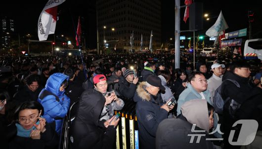 윤석열 대통령의 비상계엄 해제 요구 결의안이 국회 본회의에서 통과된 4일 새벽 서울 여의도 국회 정문 앞에 모인 시민들이 윤 대통령을 규탄하고 있다. 2024.12.4/뉴스1 ⓒ News1 장수영 기자