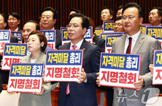 국민의힘 송언석 원내대표를 비롯한 의원들이 26일 오전 서울 여의도 국회에서 열린 의원총회에서 김민석 국무총리 후보자 지명 철회를 촉구하는 손피켓을 들고 구호를 외치고 있다. 2025.6.26/뉴스1 ⓒ News1 김민지 기자