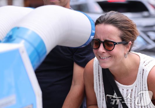 절기상 중복인 30일 서울 종로구의 한 삼계탕집 앞에서 더위에 지친 외국인 관광객이 냉풍기 바람으로 더위를 식히고 있다. 2025.7.30/뉴스1 ⓒ News1 박지혜 기자