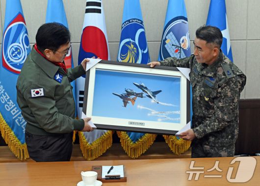 우원식 국회의장이 14일 강원도 원주시 제8전투비행단을 위문 방문, 이긍규 8전투비행단장에게 전투기 사진액자를 전달받고 있다. 2026.1.14/뉴스1 ⓒ News1 국회사진기자단