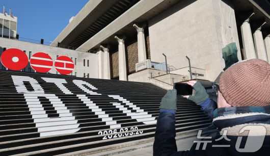 6일 오전 서울 종로구 세종문화회관 야외 계단에 설치된 BTS(방탄소년단)의 컴백 로고 조형물 앞에서 관광객이 기념촬영을 하고 있다. BTS는 3월 20일 컴백과 새 앨범 발매, 월드투어 일정을 공식 발표했다. 2026.1.6/뉴스1 ⓒ News1 임세영 기자