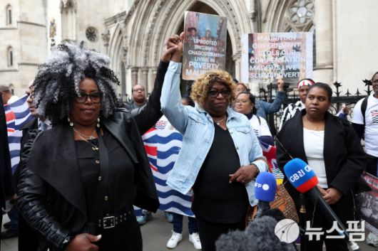 인도양 차고스 제도 출신의 영국 시민권자 여성 2명이 22일(현지시간) 차고스 제도 주권의 모리셔스 이양을 막아달라는 가처분 신청이 법원에서 인용된 뒤 기뻐하고 있다. 하지만 이 같은 법원 결정을 10시간 만에 뒤집혔다. [사진=로이터 뉴스핌]