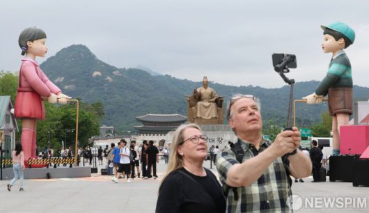 [서울=뉴스핌] 김학선 기자 = 29일 서울 광화문 광장에서 열린 '2025 K-콘텐츠 서울여행주간 : 오징어 게임 팝업 광화문' 행사를 찾은 외국인 관광객들이 기념사진을 찍고 있다. '오징어 게임 팝업 광화문'은 내달 6일까지 열리며 현장에는 오징어 게임 속 상징적인 요소들을 체험할 수 있는 다양한 포토존과 전시, 미니 게임 등이 마련돼 있다. 2025.06.29 yooksa@newspim.com