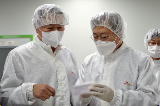 문재인 대통령이 20일 오전 경북 안동시 SK바이오사이언스 공장에서 코로나19 백신 생산 현장을 시찰하며 최태원 SK회장과 대화하고 있다. 연합뉴스