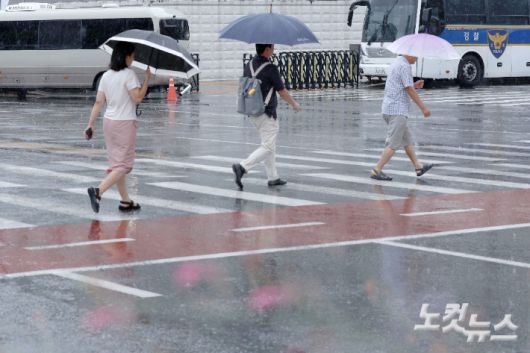 전국이 대체로 흐리고 비가 내린 지난달 6일 서울 종로구 광화문 광장에 우산을 쓴 시민들이 발걸음을 옮기고 있다. 류영주 기자