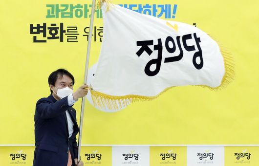 2020년 10월11일 당시 김종철 정의당 신임 대표가 서울 여의도 국회에서 열린 정의당 5·6기 지도부 이·취임식에서 당기를 흔들고 있다. 연합뉴스