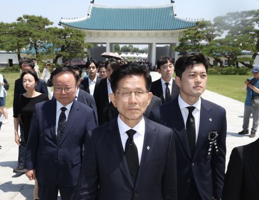 국민의힘 김문수 전 대선 후보(가운데)가 현충일인 지난 6일 오전 서울 동작구 국립서울현충원에서 김용태 비상대책위원장(오른쪽), 대선 캠프 참모들과 함께 현충탑에 참배하기 위해 시민들 뒤로 줄 서고 있다. 뉴시스