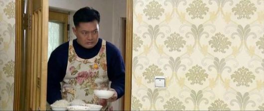 조선중앙TV 드라마 '백학벌의 새봄' 속 남성이 꽃무늬 앞치마를 입고 아내와 딸에게 밥을 차려주고 있다. 연합뉴스(조선중앙TV 캡처)