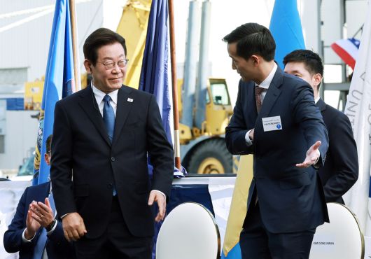 이재명 대통령이 26일(현지 시간) 필라델피아 한화 필리조선소에서 열린 미국 해양청 발주 국가안보 다목적선 '스테이트 오브 메인'호의 명명식에서 김동관 한화그룹 부회장의 안내를 받고 있다. 뉴시스