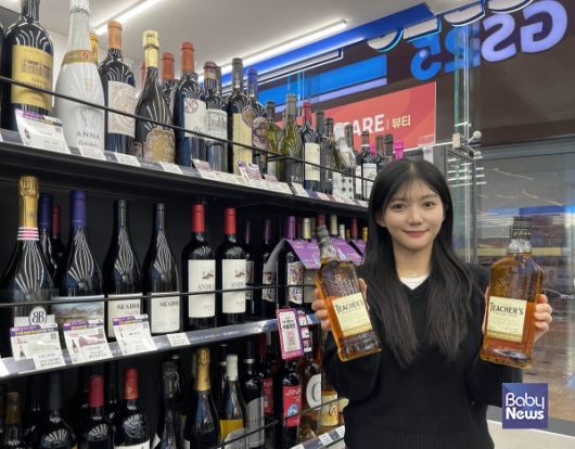 모델이 GS25에서 선보인 1만원대 가성비 위스키 '티처스' 상품을 들고 있다. ⓒGS25