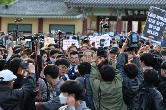 2일 오후 광주 북구 국립5·18민주묘지를 찾은 한덕수 전 총리가 광주비상행동 등 진보진영 단체 관계자들에게 가로막혀 참배하지 못하고 발길을 돌리고 있다. /연합