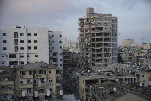 이스라엘 구조대가 15일(현지시간) 텔아비브 인근에서 이란의 탄도미사일에 피격된 건물을 수색하고 있다.AP·연합