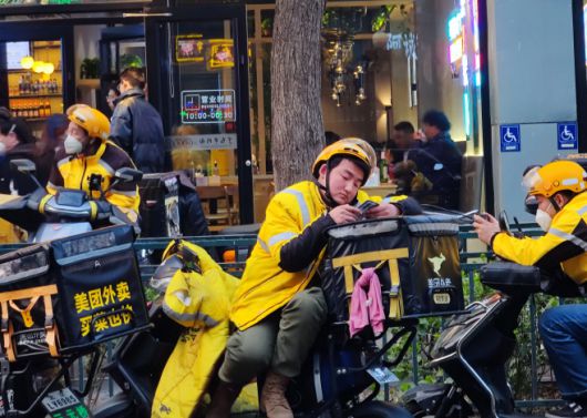 중국 경제에 과거에는 찾아볼 수도 없었던 가격 인하 경쟁 바람이 거세게 불고 있다. 그럼에도 소비 진작에 미치는 영향은 미미하기만 하다. 일거리가 없어 스마트폰을 만지작거리는 라이더의 모습에서 이 사실은 증명된다고 할 수 있다./징지르바오.