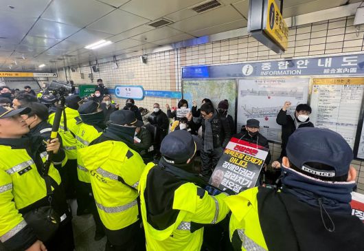 박경석 전국장애인철폐연대(전장연) 대표와 활동가들이 24일 오전 서울 종로구 지하철 4호선 혜화역에서 서울교통공사의 지하철 행동 원천 봉쇄에 대한 입장 발표 기자회견 후 이동권 시위를 시도하고 있다. 2023.11.24. 뉴스1