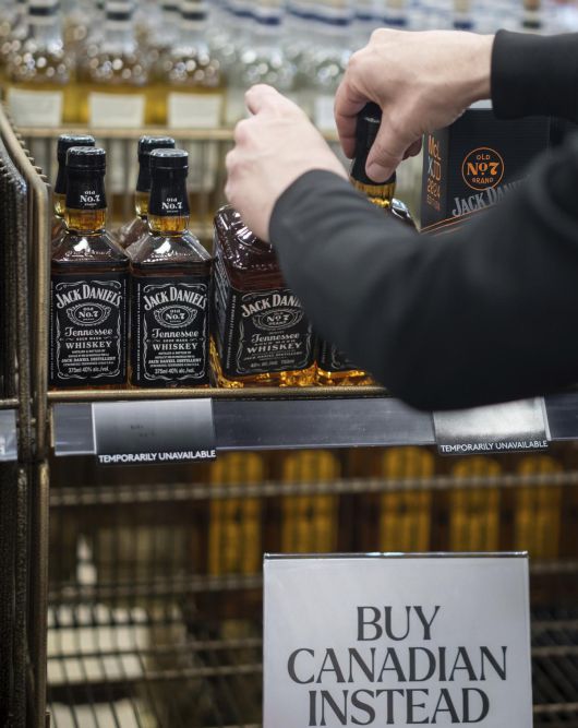 “캐나다산 삽시다”… 매장서 치워지는 미국산 잭대니얼스 위스키 2일(현지 시간) 캐나다 밴쿠버의 상점에서 직원이 매장에 진열된 미국산 잭대니얼스 위스키를 치우고 있다. 아래에 “(미국산 위스키 대신) 캐나다 상품을 사라”란 문구도 놓여 있다. 도널드 트럼프 미국 대통령이 하루 전 캐나다산 상품에 25%의 관세를 부과하겠다고 밝히자 캐나다 전역에서는 미국 제품 불매 및 국산품 애용 운동이 벌어지고 있다. 밴쿠버=AP 뉴시스