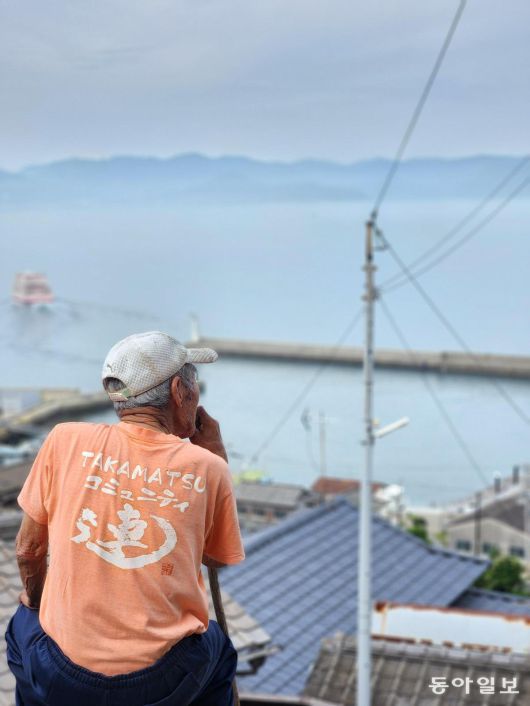 오기지마 마을 정상에서 한 지역 주민이 섬 앞바다를 바라보는 모습. 세토우치 예술제는 고령자가 대부분인 지역 주민이 행사 전반에 관여한다.